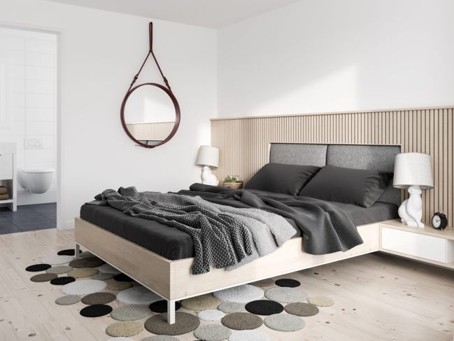 Dieser kreative Bodenbelag verleiht der minimalistischen Einrichtung dieses Schlafzimmers ein bisschen Flair und Individualität.